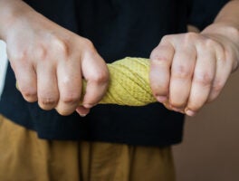 Hands,Squeeze,Wet,Fabric,Against,Brown,Background.,Draining,Water,From