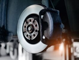 Closeup,View,Of,Car,Brake,Disc,And,Caliper,In,Mechanic